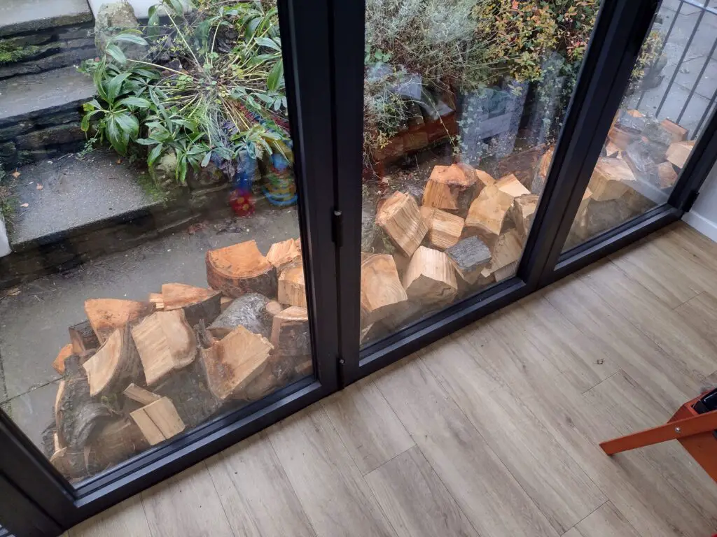 window Chopping Wood Part 3 - Injuries, Exercise & Storing Timber save money blisters gloves hole pieces pile logs rain damp fitness burner job run dry protection wet weather tarp space shelter room shed stockpile heating energy axe tools