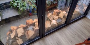 window Chopping Wood Part 3 - Injuries, Exercise & Storing Timber save money blisters gloves hole pieces pile logs rain damp fitness burner job run dry protection wet weather tarp space shelter room shed stockpile heating energy axe tools