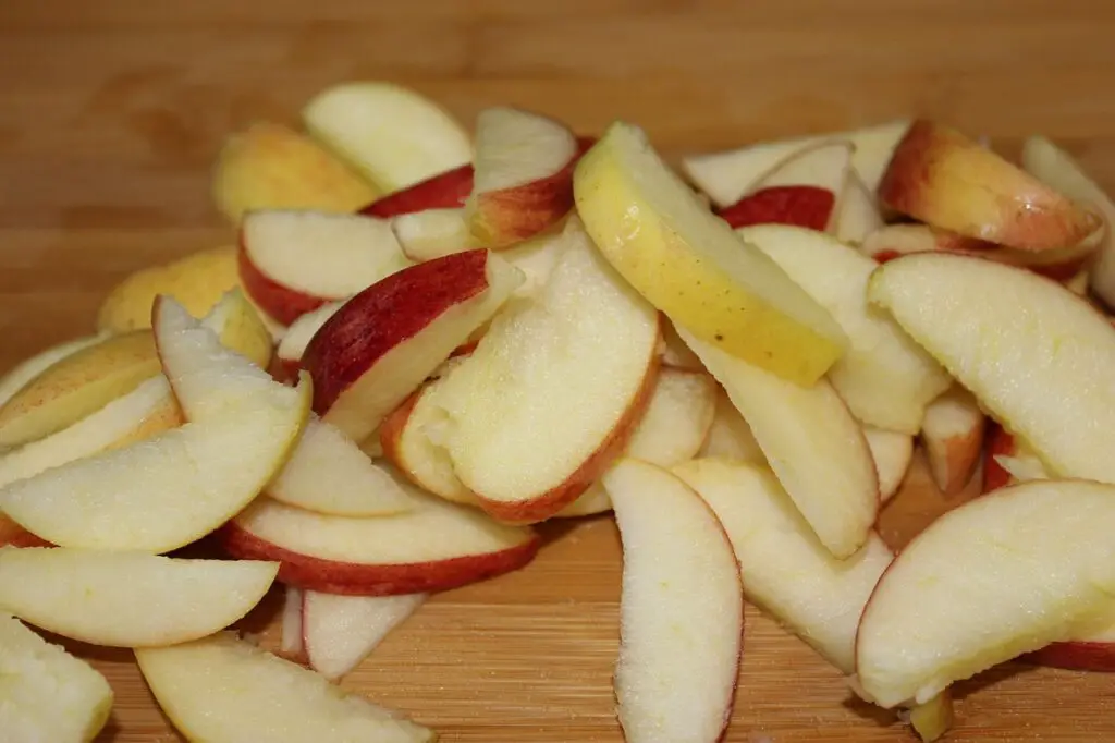 slices Baking Apple Pie Part 2: Cutting Out Flaws & Creating Pastry save money cut create variety amount flexible experiment preference different discovery taste  damage bruise bite marks wild animals chop quarter core peel knife dry pieces strips thin thick bowl water brown recipe mix dough sugar butter margarine cheap electric  stand mixer whisk eggs flour attachment sturdy hook refrigerate ball hour fridge easy pliable filling nutmeg cinnamon stir drain seeds skin