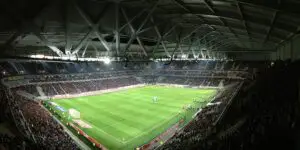 interior of a crowded football stadium at night time