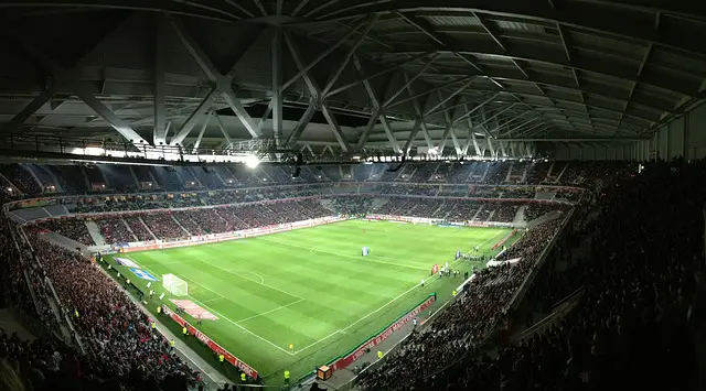 interior of a crowded football stadium at night time