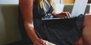 woman on a laptop writing notes