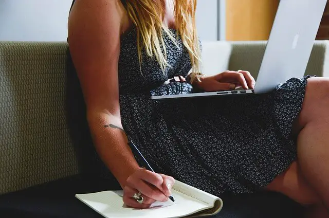 woman on a laptop writing notes