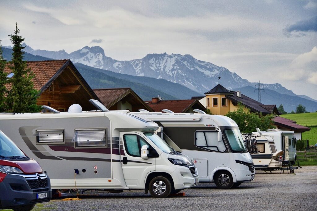 RV next to building and mountain